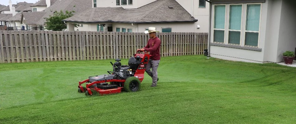 Professional in Barton Creek, TX, mowing grass.